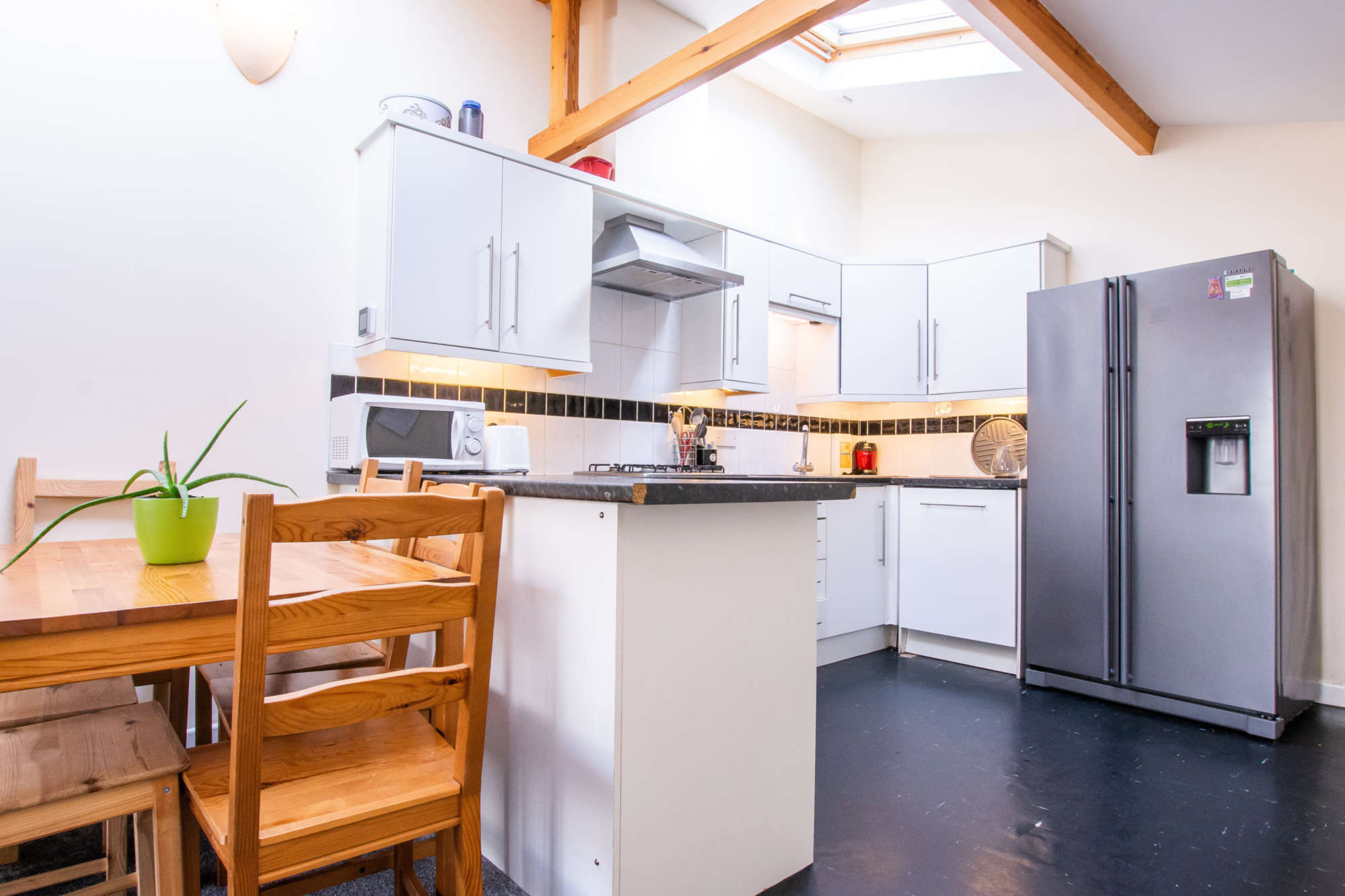 Kitchen with feature beams and American fridge/freezer