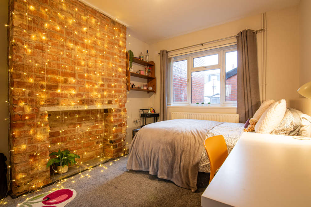 Ground floor bedroom with exposed chimney breast feature